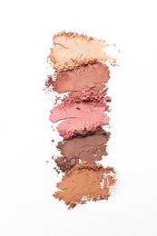 Photo of Crushed eye shadows on white background, top view. Professional makeup product