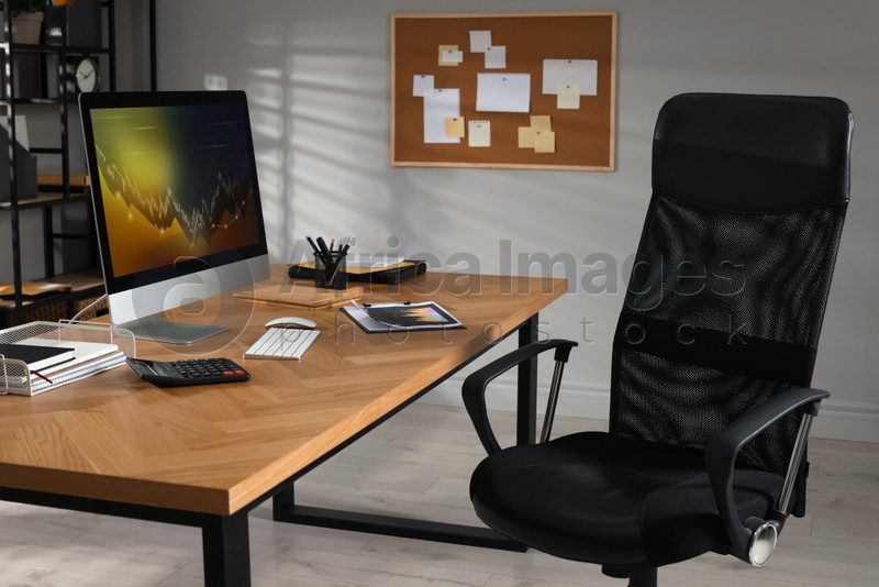 Computer with graph on table in office