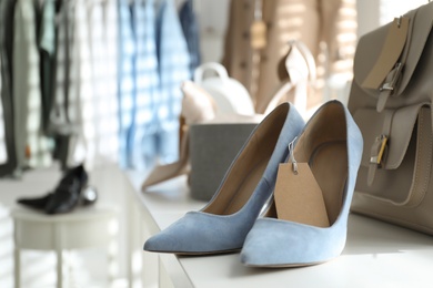Women's high heel shoes and accessories in modern clothing boutique, space for text