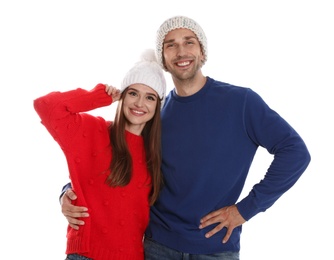 Happy young couple in warm clothes on white background. Winter season