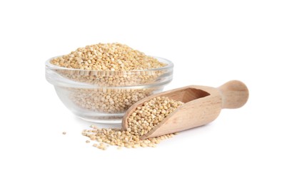 Photo of Glass bowl and wooden scoop with quinoa on white background