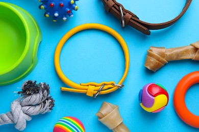 Flat lay composition with dog collars and different accessories on light blue background