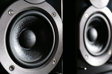 Modern powerful audio speakers as background, closeup