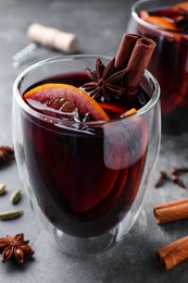 Aromatic mulled wine on grey table, closeup