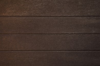 Texture of dark brown wooden surface as background