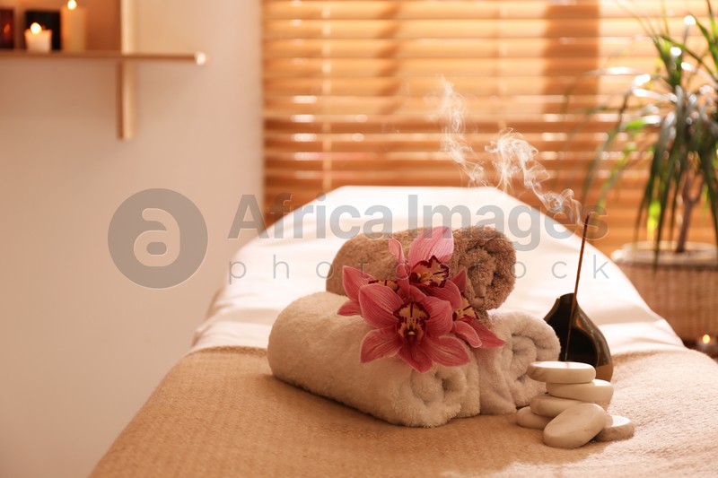 Photo of Beautiful spa accessories in massage room, space for text