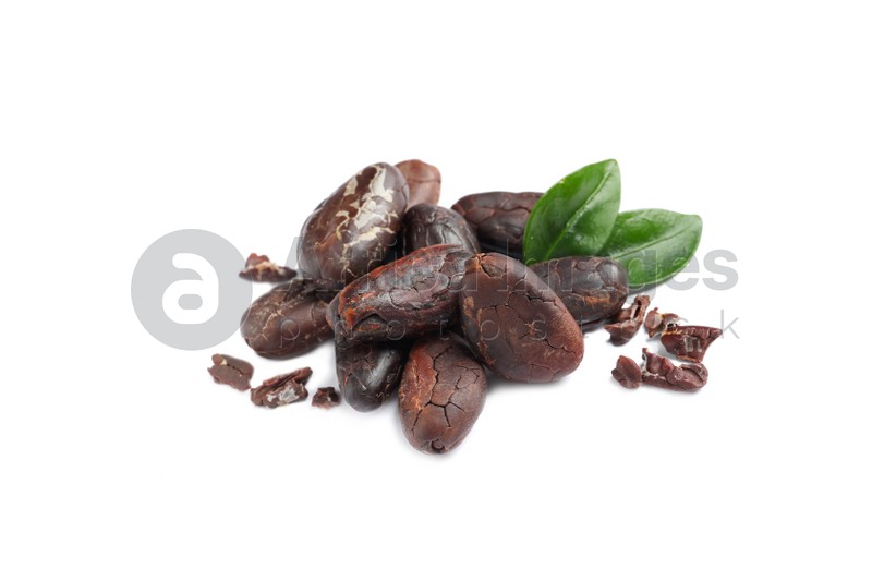 Pile of aromatic cocoa beans with leaves isolated on white