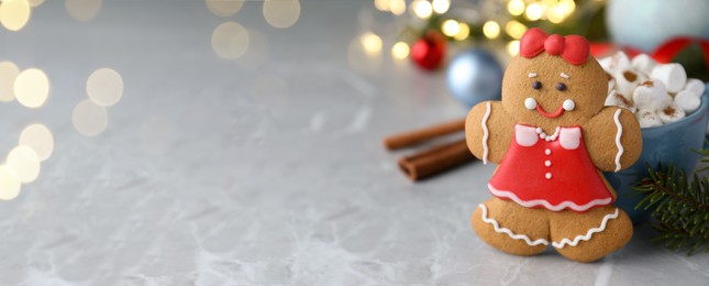 Image of Gingerbread girl on grey marble table, space for text. Banner design