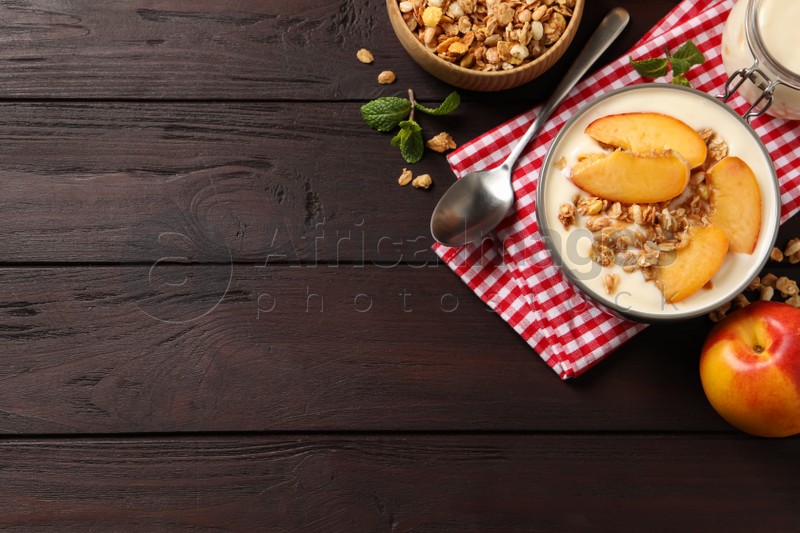 Flat lay composition with tasty peach yogurt on wooden table. Space for text