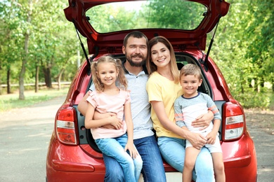 Happy family with children and car, outdoors. Taking road trip together