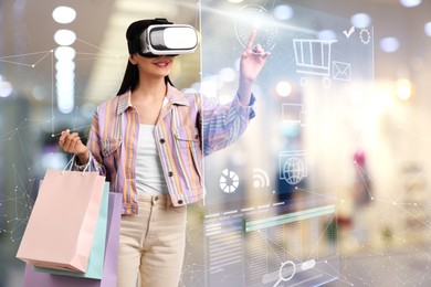 Young woman with shopping bags using virtual reality headset in simulated store