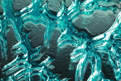 Photo of Beautiful blue gel on silver background, closeup