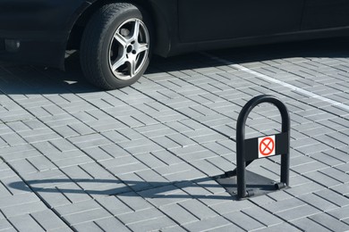 Parking barrier with No Stopping road sign on pavement near car, space for text