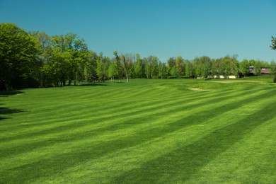Picturesque view of golf course with fresh green grass and trees