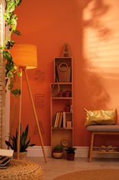 Beautiful room interior with stylish furniture near brown wall