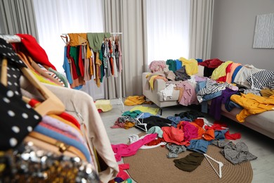 Mess of clothes all over room. Fast fashion