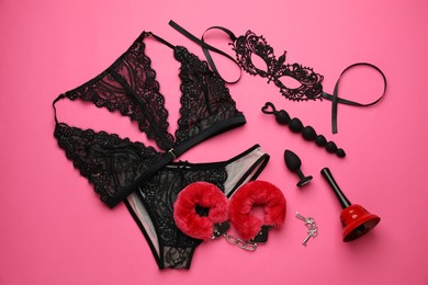 Sex toys, accessories and lingerie on pink background, flat lay