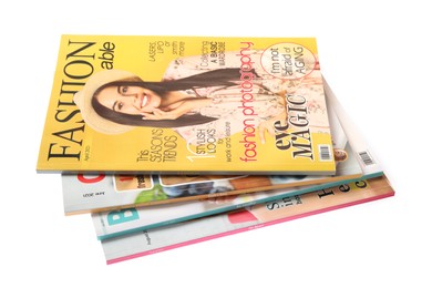 Stack of different magazines on white background
