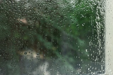 Window glass with water drops as background, closeup