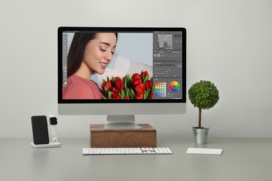 Designer's workplace. Computer with photo editor application on table