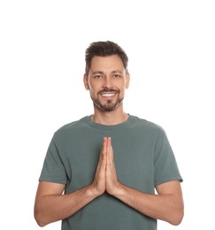 Man with clasped hands praying on white background