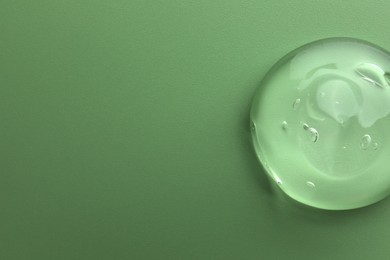 Photo of Sample of gel on green background, top view. Space for text