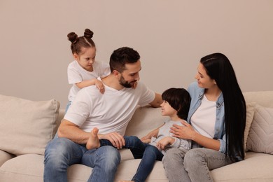 Happy family resting on sofa in living room