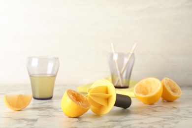 Fresh lemon half with juicer on table. Refreshing drink recipe