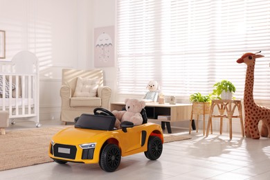 Yellow car in room at home. Child's toy