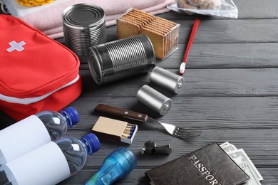 Photo of Disaster supply kit for earthquake on black wooden table