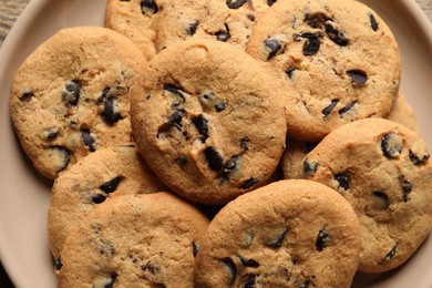 Delicious chocolate chip cookies on plate, top view