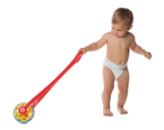 Photo of Cute baby with push toy learning to walk on white background
