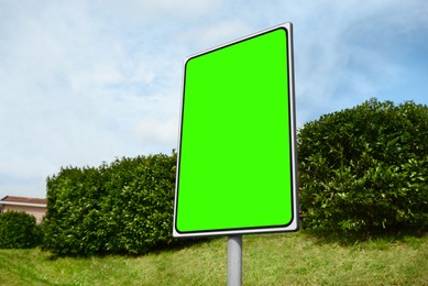 Image of Chroma key compositing. Empty billboard with green screen outdoors. Mockup for design