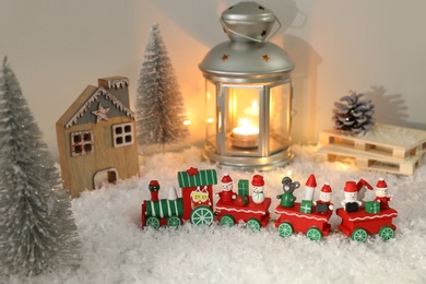 Toy train and Christmas decor on snow