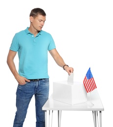 Man putting ballot paper into box against white background