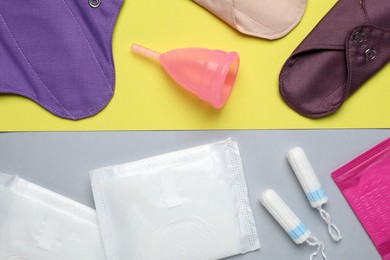 Different menstrual hygiene products on color background, flat lay
