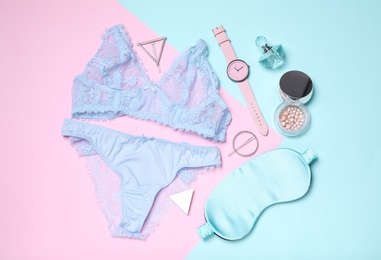 Flat lay composition with stylish lingerie and accessories on color background