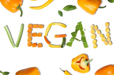 Word VEGAN made of different fresh tasty vegetables on white background, flat lay