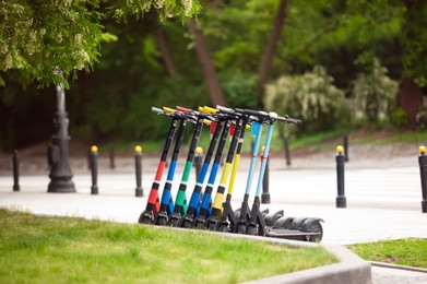Row of electric scooters in park. Rental service