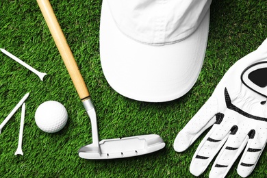 Flat lay composition with golf equipment on artificial grass