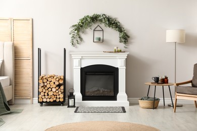 Stylish room decorated with beautiful eucalyptus garland above fireplace