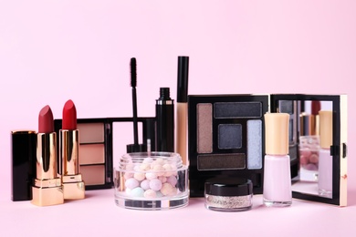 Different luxury decorative cosmetics on pink background