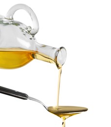 Photo of Pouring cooking oil from jug into spoon on white background, closeup