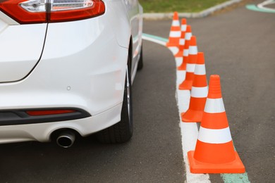 Modern car on test track with traffic cones, closeup. Driving school