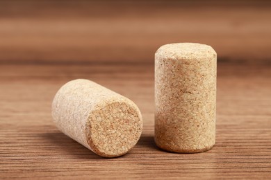 Photo of Wine bottle corks on wooden table, closeup
