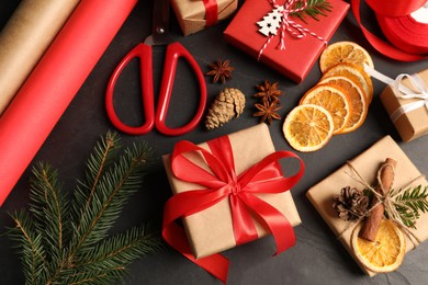 Flat lay composition with beautiful gift boxes and Christmas decorations on black table