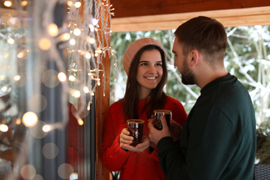 Lovely couple with tasty mulled wine in cafe. Winter vacation