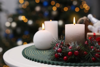 Beautiful burning candles and Christmas decor on white table indoors, space for text