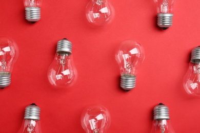New incandescent lamp bulbs on red background, flat lay