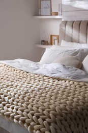 Photo of Soft chunky knit blanket on bed indoors